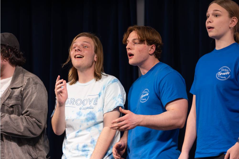 Members of acapella group GrooVe singing.